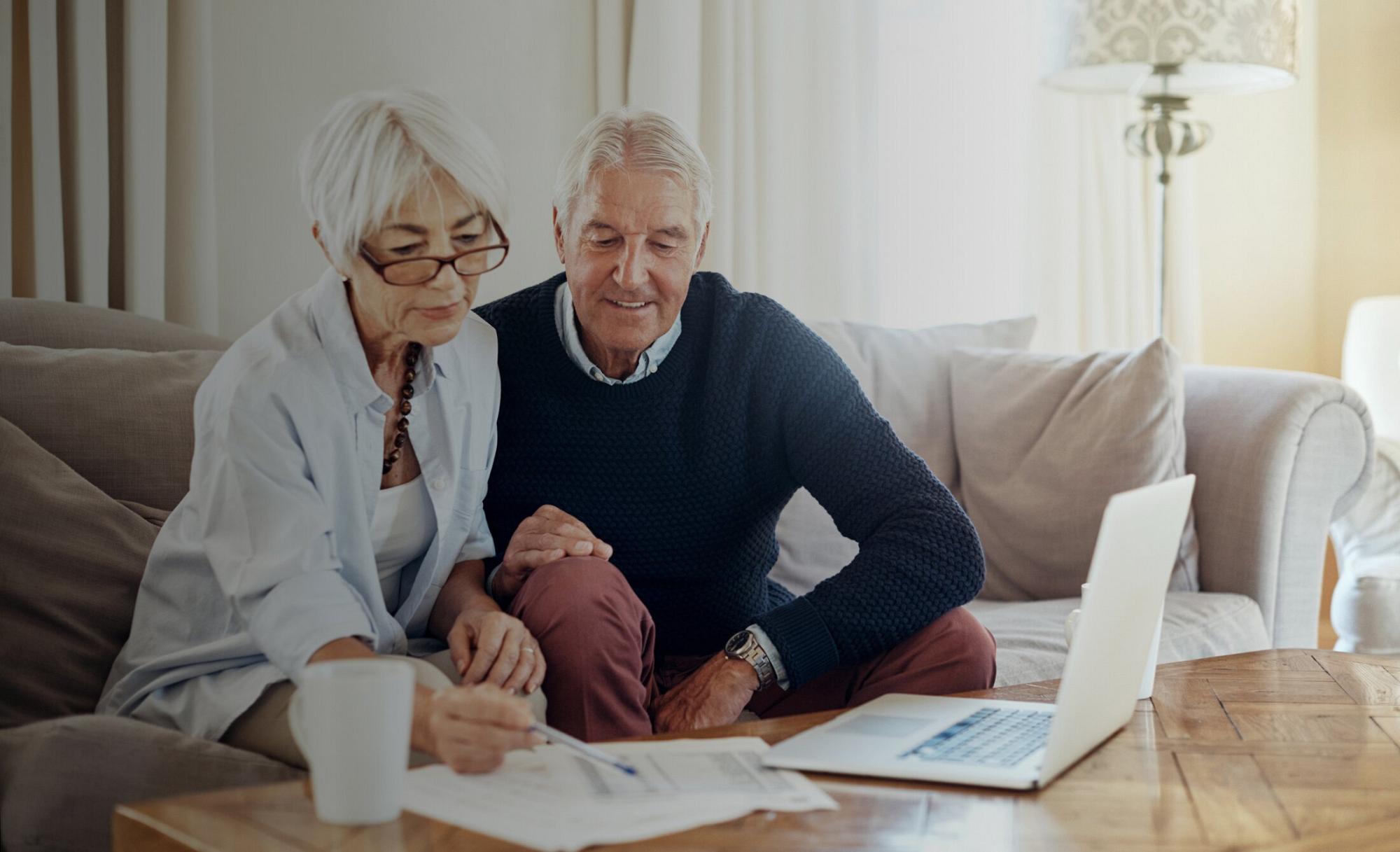 Tax Savings for Business Owners feature - Older couple reviewing financial documents